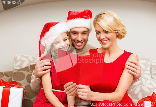 Image of smiling family reading postcard