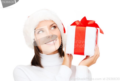 Image of smiling woman in santa helper hat with gift box