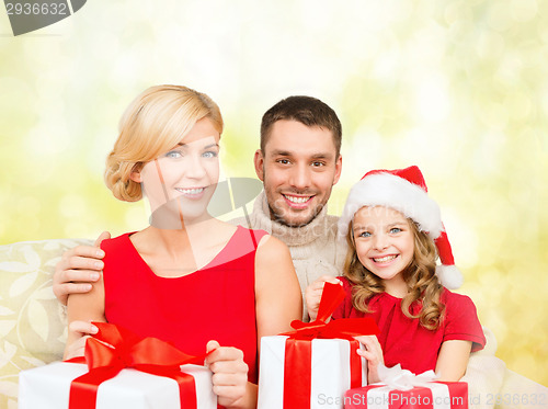 Image of smiling family holding many gift boxes