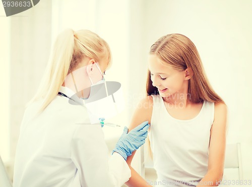 Image of doctor doing vaccine to child in hospital