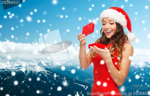 Image of smiling woman in red dress with gift box