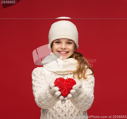 Image of girl in winter clothes with small red heart