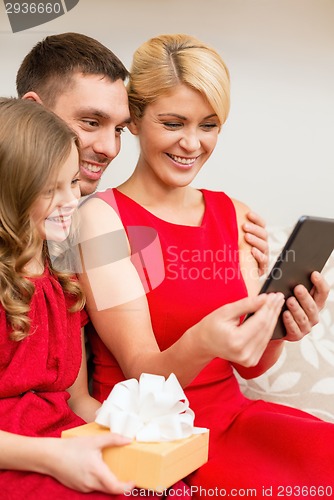 Image of smiling family with tablet pc