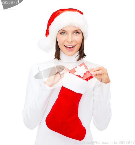 Image of woman in santa hat with gift box and stocking