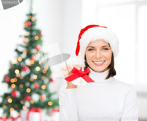 Image of smiling woman in santa helper hat and jingle bells