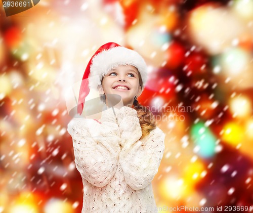 Image of dreaming girl in santa helper hat