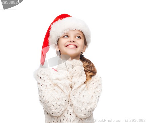 Image of dreaming girl in santa helper hat
