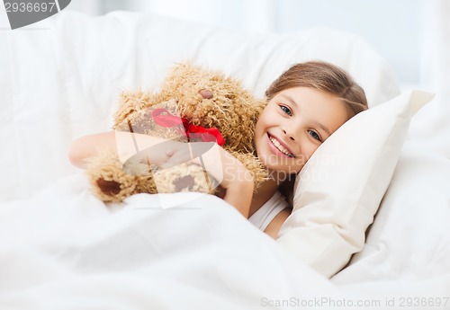 Image of little girl with teddy bear sleeping at home