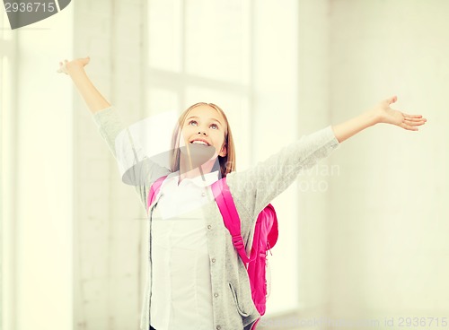 Image of student girl with hands up at school
