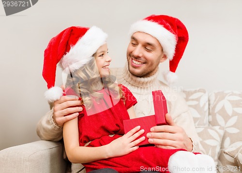 Image of smiling father and daughter opening gift box