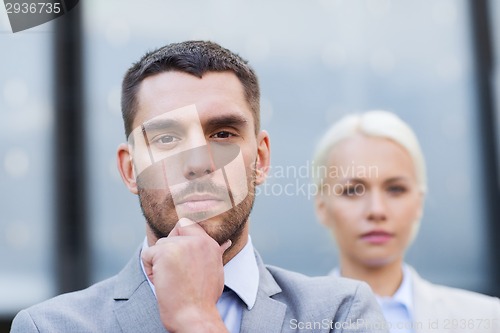 Image of businessman and businesswoman outdoors