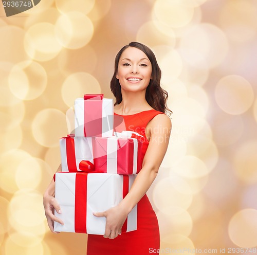 Image of smiling woman in red dress with gift box