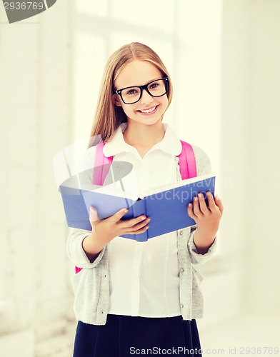 Image of girl reading book at school
