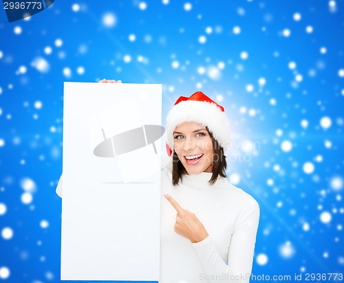 Image of smiling young woman in santa hat with white board