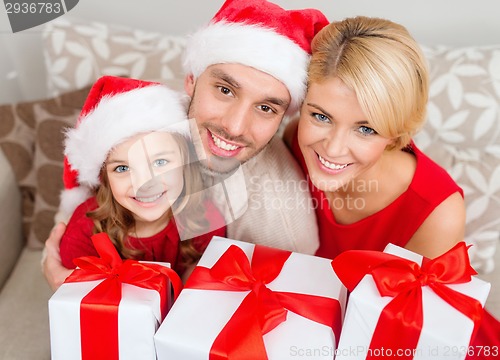 Image of smiling family holding many gift boxes