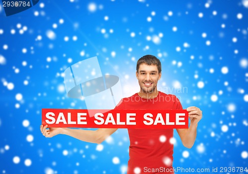 Image of man in red t-shirt with sale sign