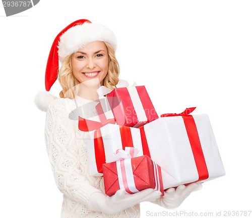 Image of woman in santa helper hat with many gift boxes