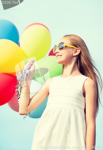 Image of happy girl with colorful balloons