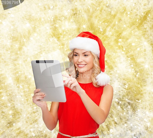 Image of woman in santa helper hat with tablet pc