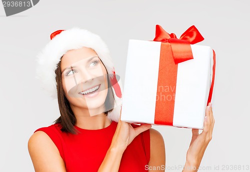 Image of smiling woman in santa helper hat with gift box