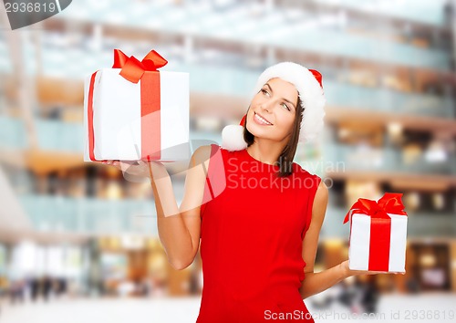 Image of smiling woman in red dress with gift box