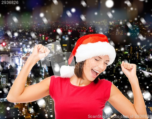 Image of smiling woman in santa helper hat