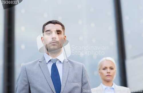 Image of businessman and businesswoman outdoors