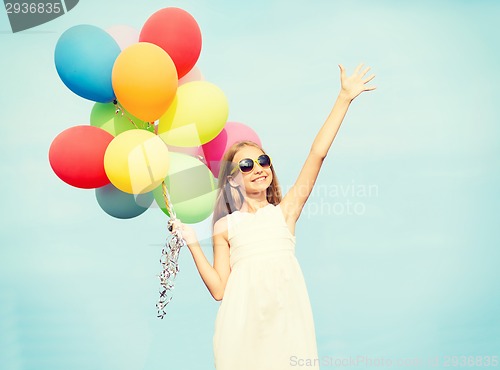 Image of happy girl with colorful balloons