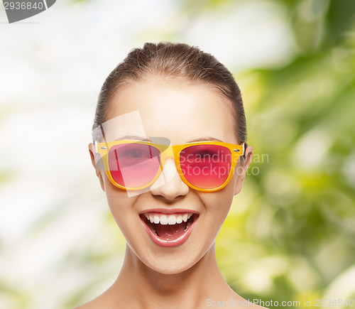 Image of happy teenage girl in pink sunglasses