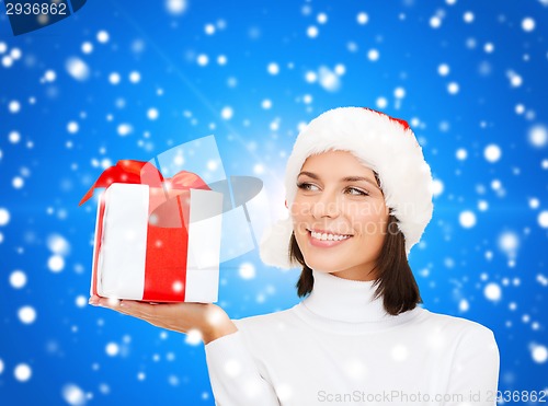Image of smiling woman in santa helper hat with gift box