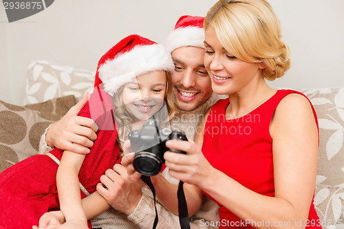 Image of family in santa helper hats looking at pictires