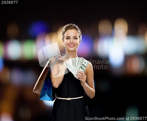 Image of smiling woman in dress with shopping bags