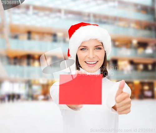 Image of woman in santa helper hat with blank red card
