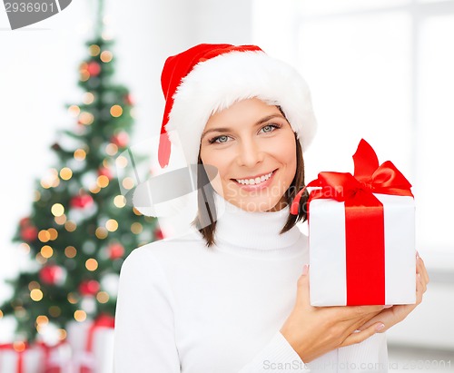 Image of smiling woman in santa helper hat with gift box