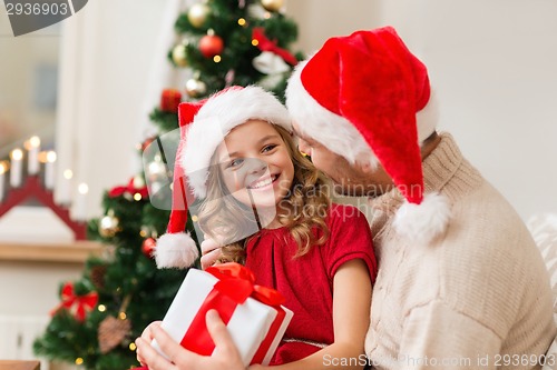 Image of smiling father and daughter holding gift box