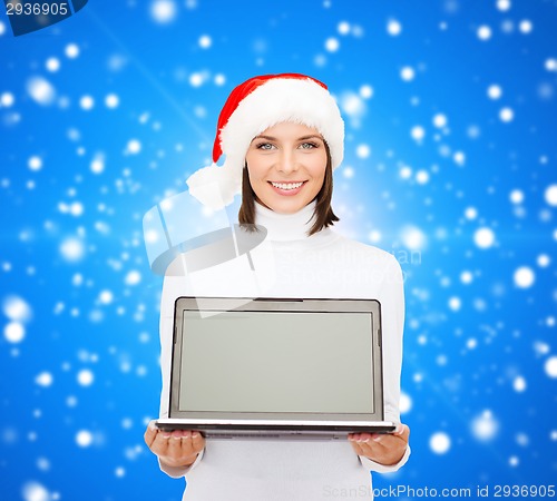 Image of woman in santa helper hat with laptop computer