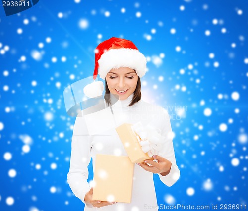 Image of smiling woman in santa helper hat with gift box