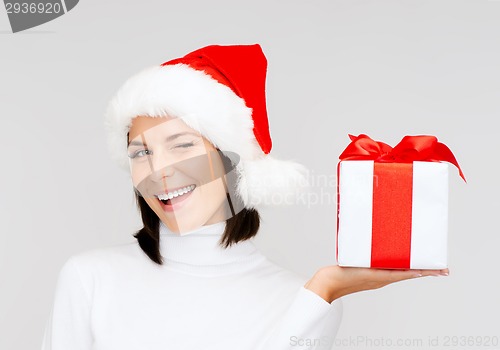 Image of smiling woman in santa helper hat with gift box