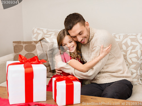 Image of smiling father and daughter hugging