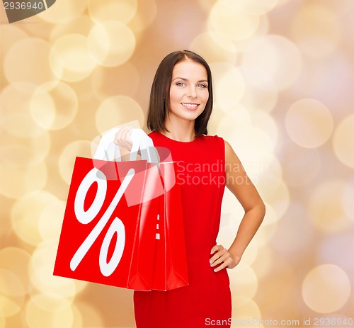Image of woman in red dress with shopping bags