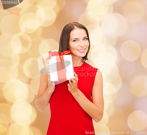 Image of smiling woman in red dress with gift box