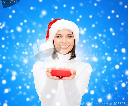 Image of smiling woman in santa helper hat with gift box