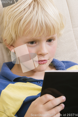 Image of Little boy reading a book
