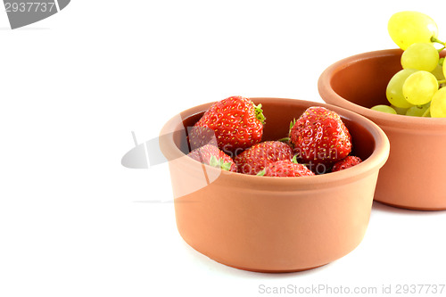 Image of Grapes and strawberries in a bowl, isolated on white