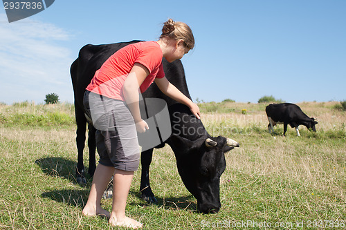 Image of Young girl with cows