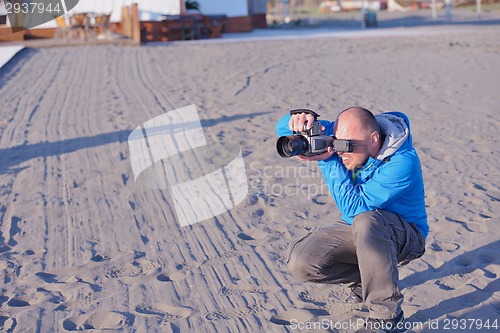 Image of photographer taking photo on beach