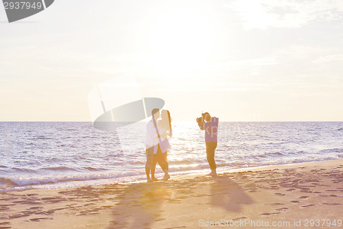 Image of photographer taking photo on beach