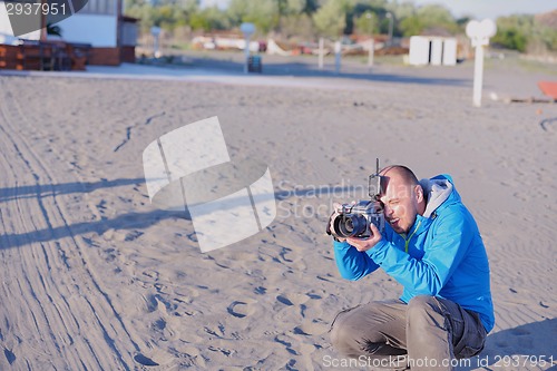 Image of photographer taking photo on beach
