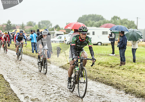 Image of The Cyclist Yukiya Arashiro on a Cobbled Road - Tour de France 2