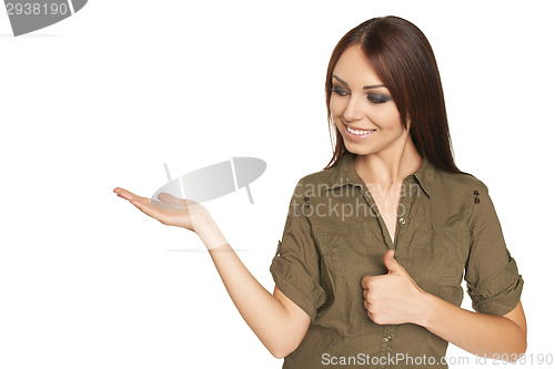 Image of Surprised young woman showing open hand palm